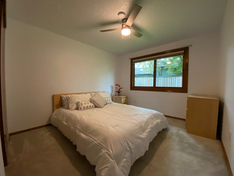 2nd Bedroom - backyard view.  Ceiling fan and blackout up-down/down-up window covering.