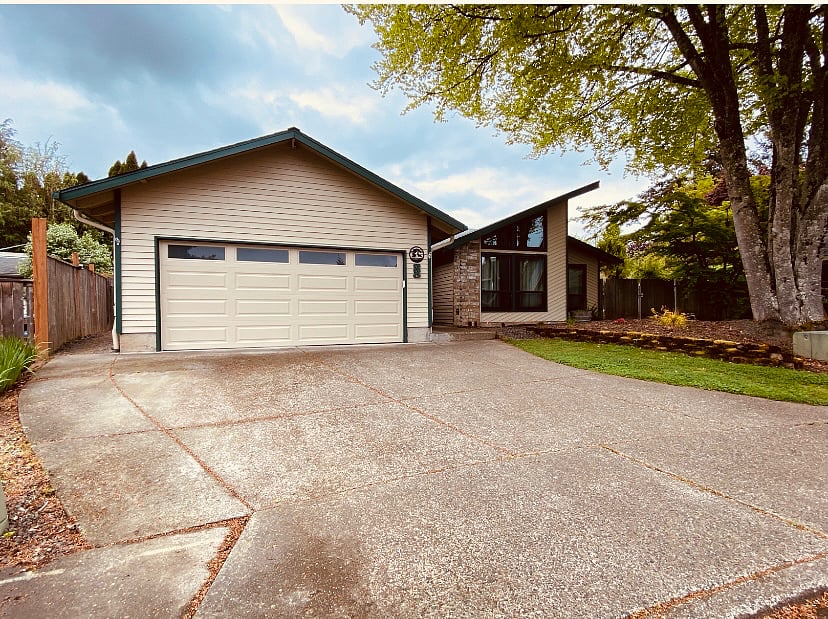 Front entry on quiet cul-de-sac with garage door opener and well-lit entrance.