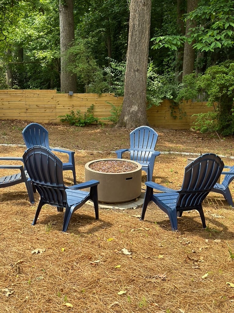 Enjoy a propane fire pit with Adirondack chairs