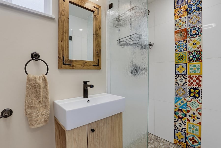 Walk-in glass shower with custom Talavera tile