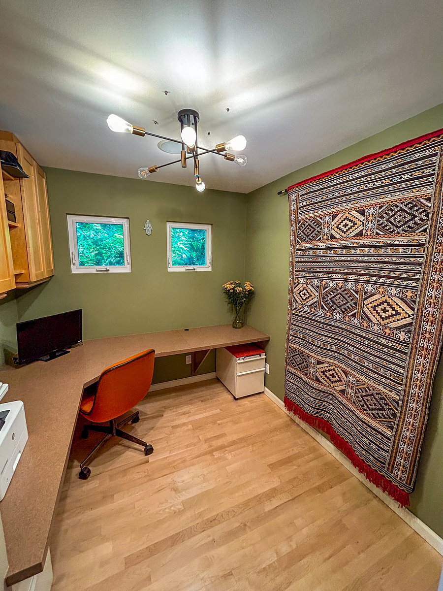 Great work office with Moroccan rugs and comfy chair.
