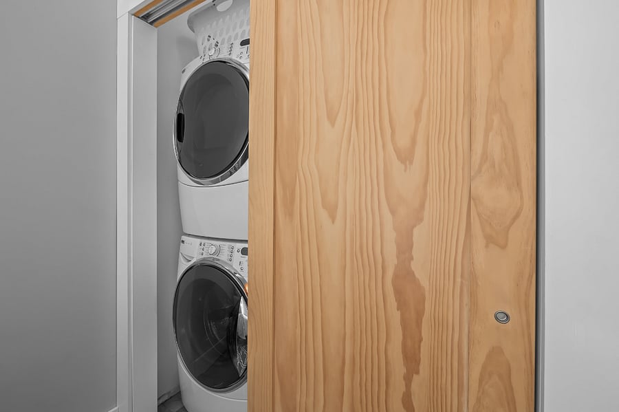 The extra large sliding door closet hides away many things, including a stackable washer & dryer.
