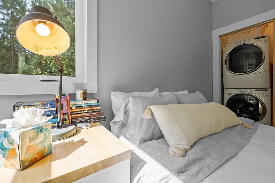 The queen size bed has a nightstand with lots of books to choose from & a bedside lamp for curling up w/ a good book! The nighstand also has room for storage.