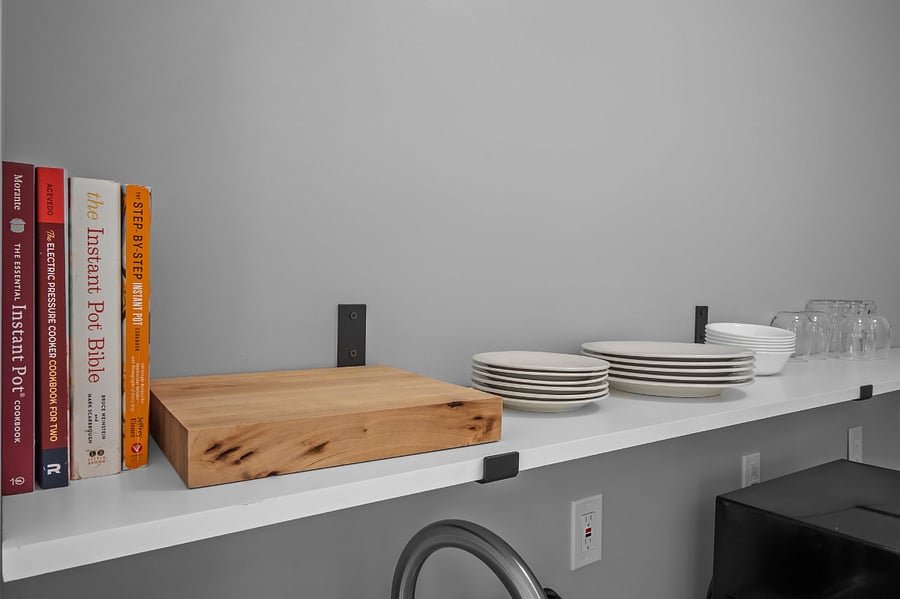 Kitchen includes features like cookbooks, cutting boards, & plenty of dishes.