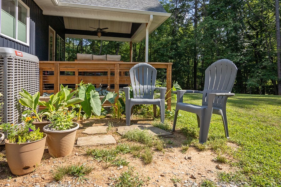 A small sitting area with (lightweight / portable!) adirondack chairs gives option to enjoying the backyard!