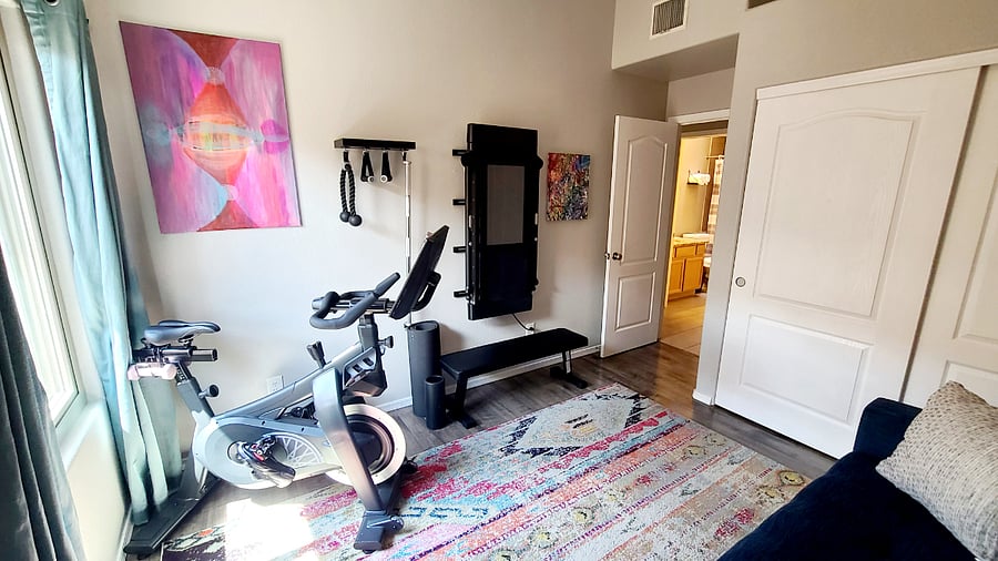 Stay active and inspired in our Movement Room, featuring a SoulCycle smart bike, Tonal home gym, yoga mats, and vibrant decor to keep you motivated. It's a dedicated space for your fitness routine, right within the comfort of our home.