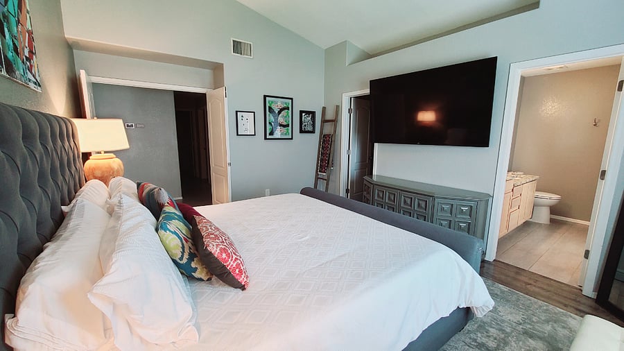 Retreat to our Peaceful Prime ensuite bedroom, featuring a 70" LG Smart TV, a walk-in closet, a spacious bathtub and shower, and an incredibly comfortable king-size bed with luxurious pillows. It's a haven of relaxation and comfort.