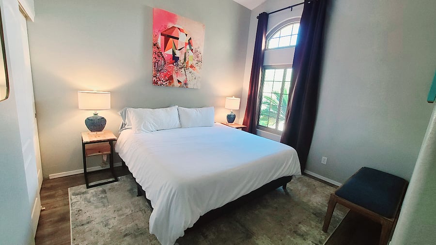 Experience the tranquility of our Tranquil Time Bedroom, featuring wonderfully high ceilings, room-darkening curtains, and a spacious closet with ample room for all your belongings. It's a serene space designed for your utmost comfort.