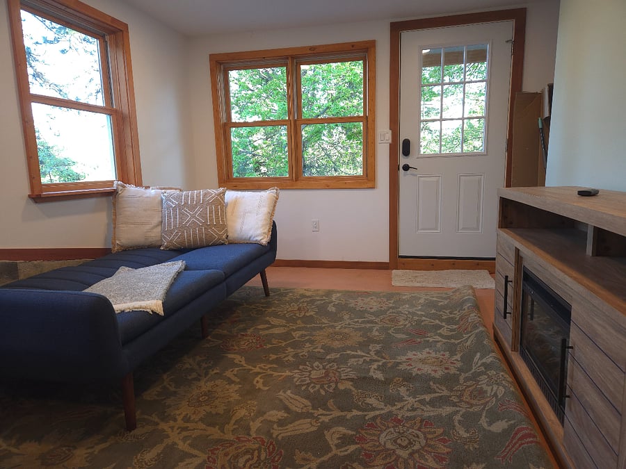 Couch folds into a small futon bed for movie nights.  Living room has lots of natural light.