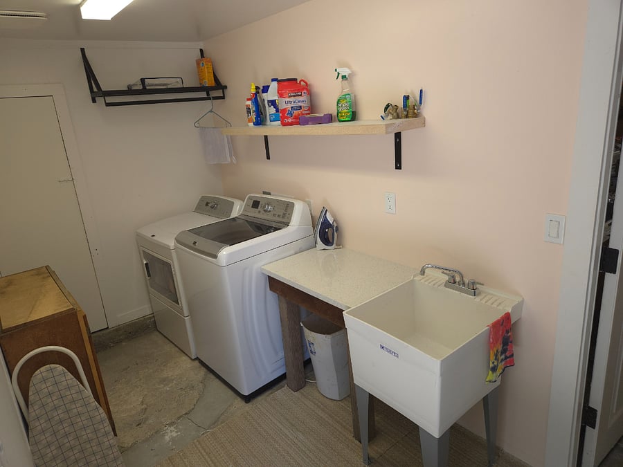 Small but efficient laundry room with large load washer and dryer.  Large wash sink, compact ironing board and soaps available for use.