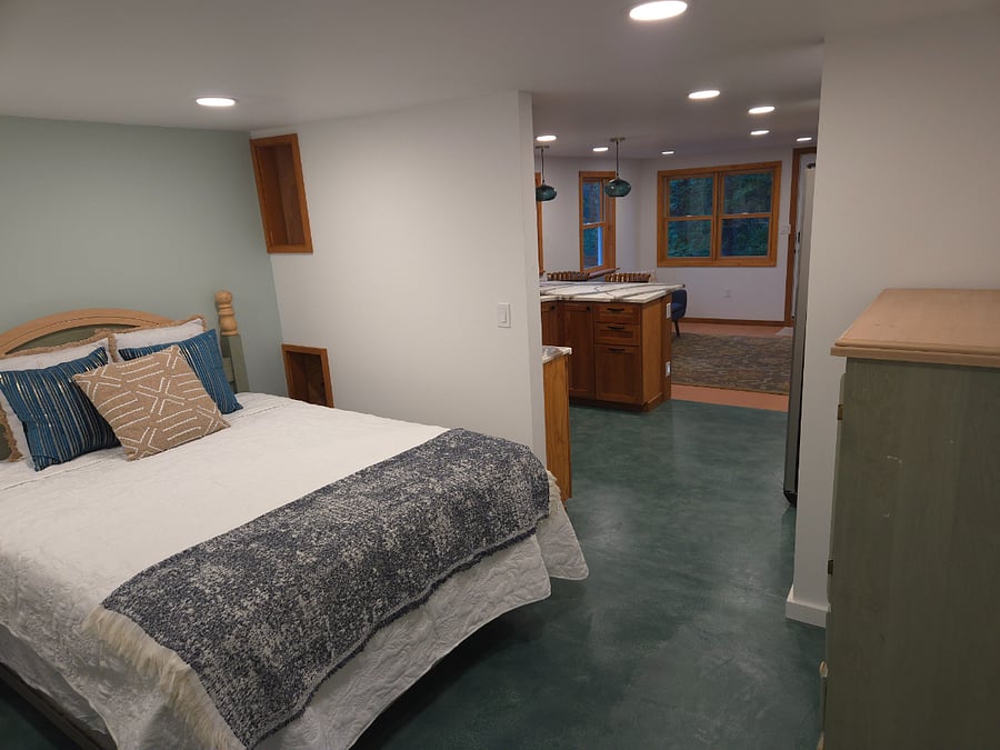 View from bathroom door, across bedroom and into living room.