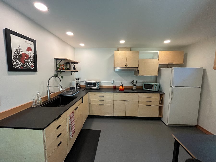 Kitchen with 4-burner cooktop, microwave, countertop oven and refrigerator