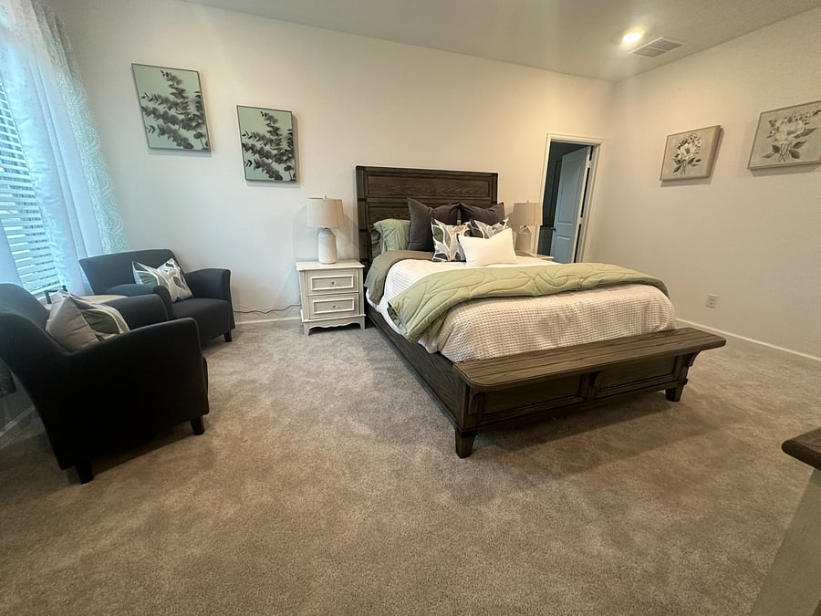 Suite with attached bathroom. This room features a queen bedroom set with a 50 inch television and a sitting area.