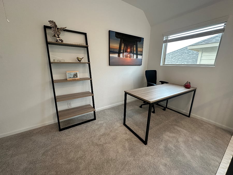 Dedicated work space with an adjustable chair, a book shelf and wireless printer.