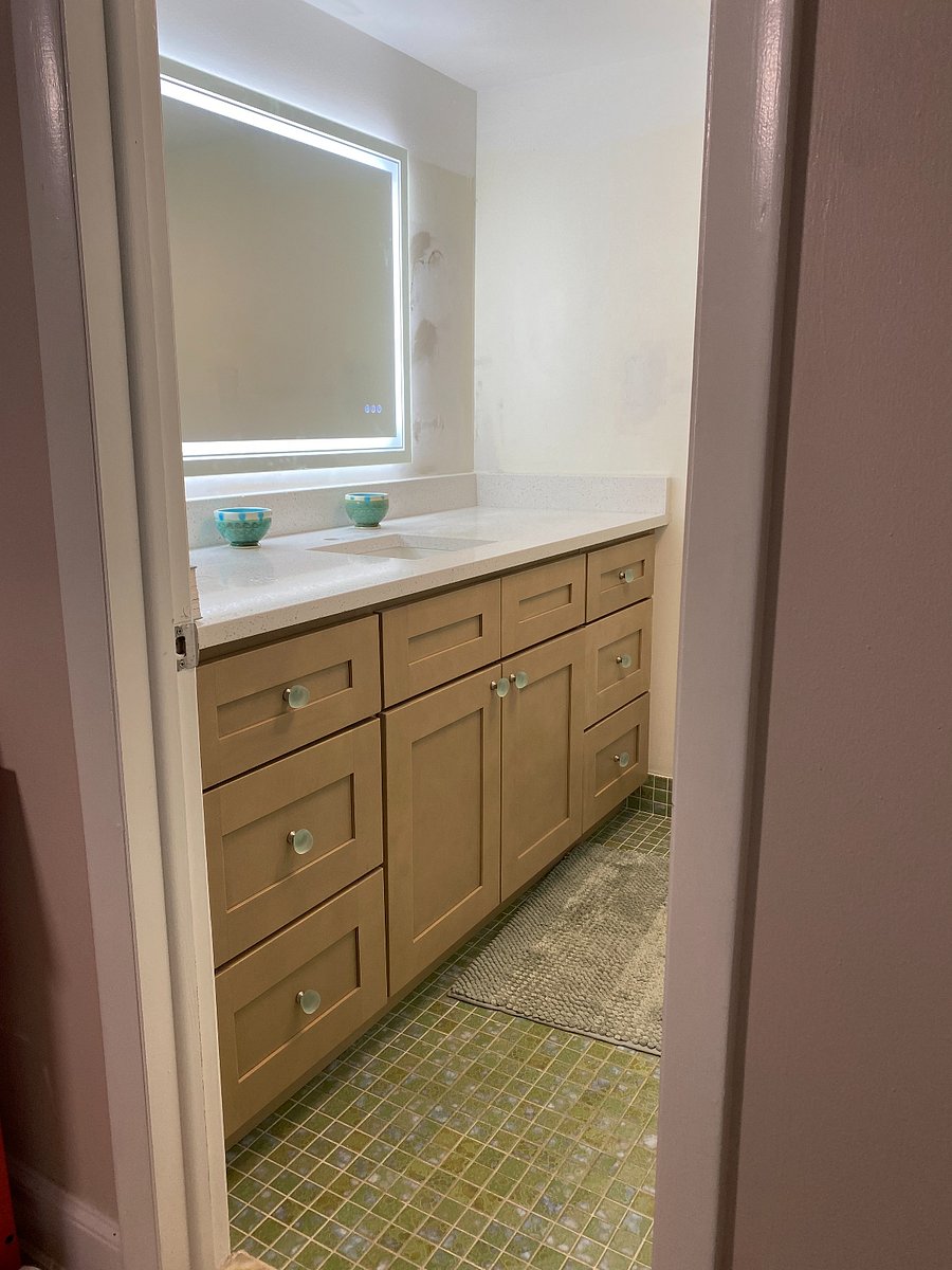 Master bathroom with updated vanity, counter, sink, mirror and paint