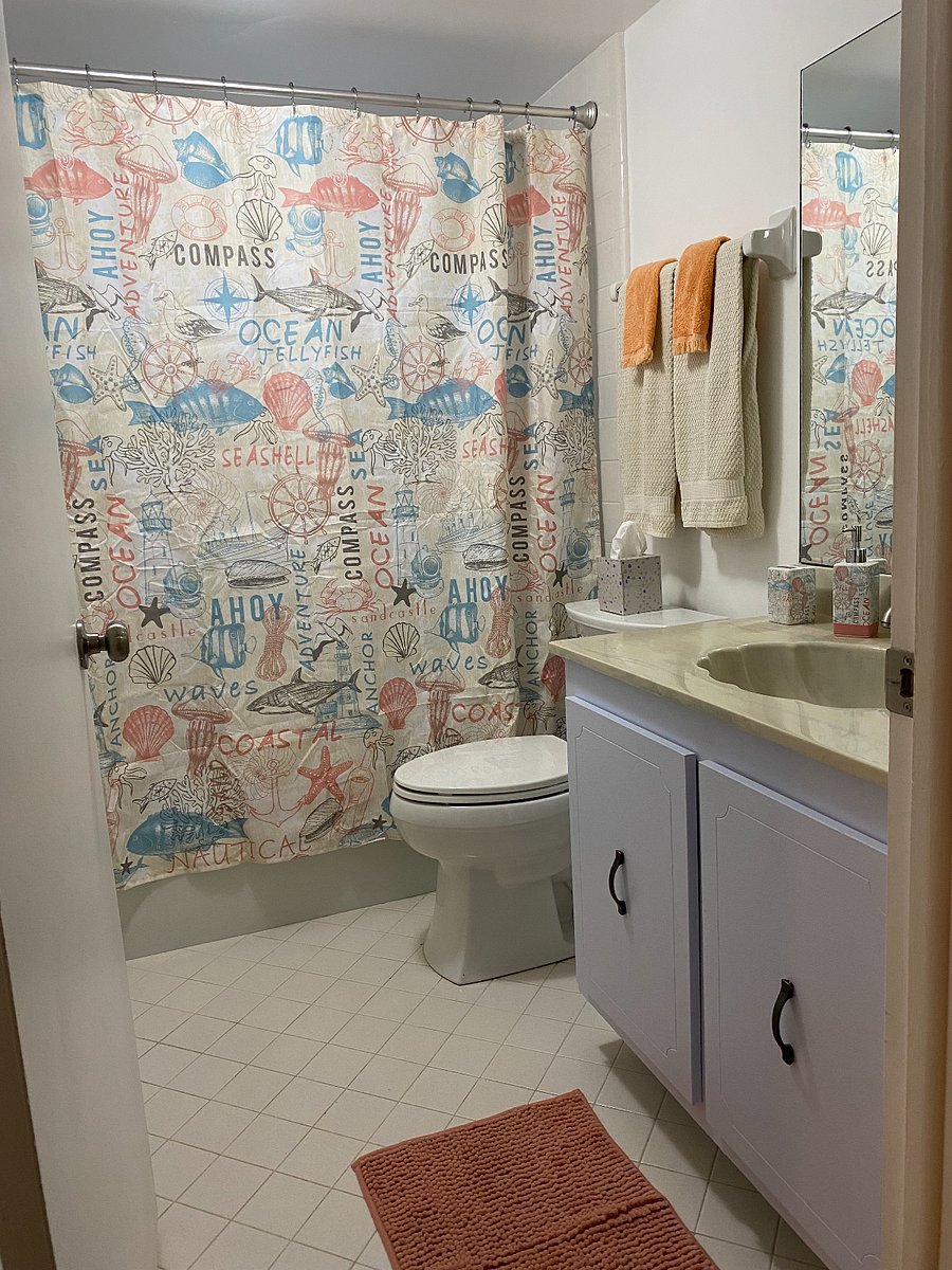 Guest/hall bathroom. Laundry area is in the bathroom to the left behind bifold doors