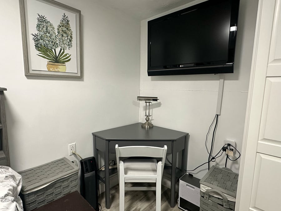 Small Workspace and Roku TV. Hampers for Laundry.