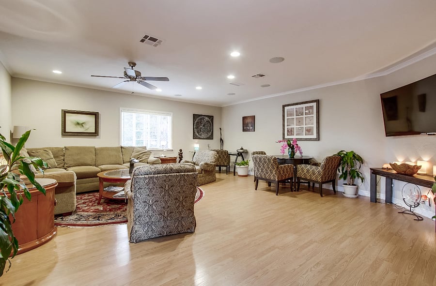 ChatGPT

The expansive living room boasts exquisite furnishings and captivating artwork, complemented by a game table and a generously-sized smart TV.