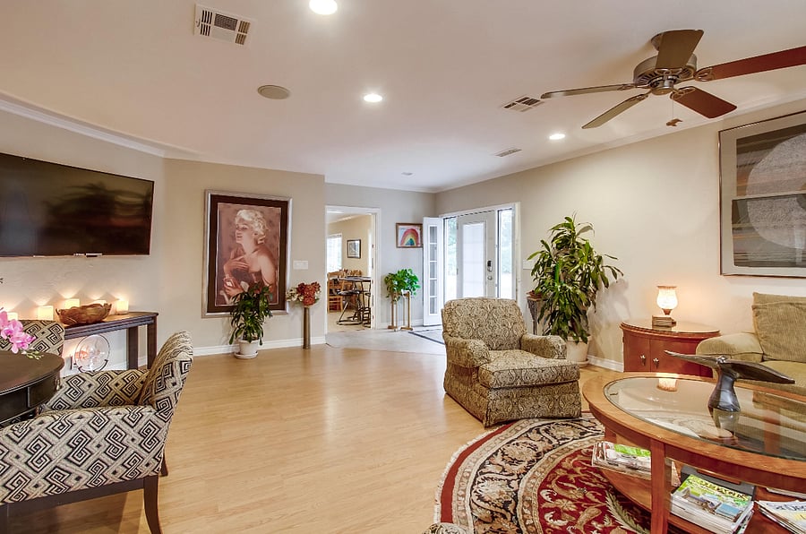 ChatGPT

The expansive living room boasts exquisite furnishings and captivating artwork, complemented by a game table and a generously-sized smart TV.