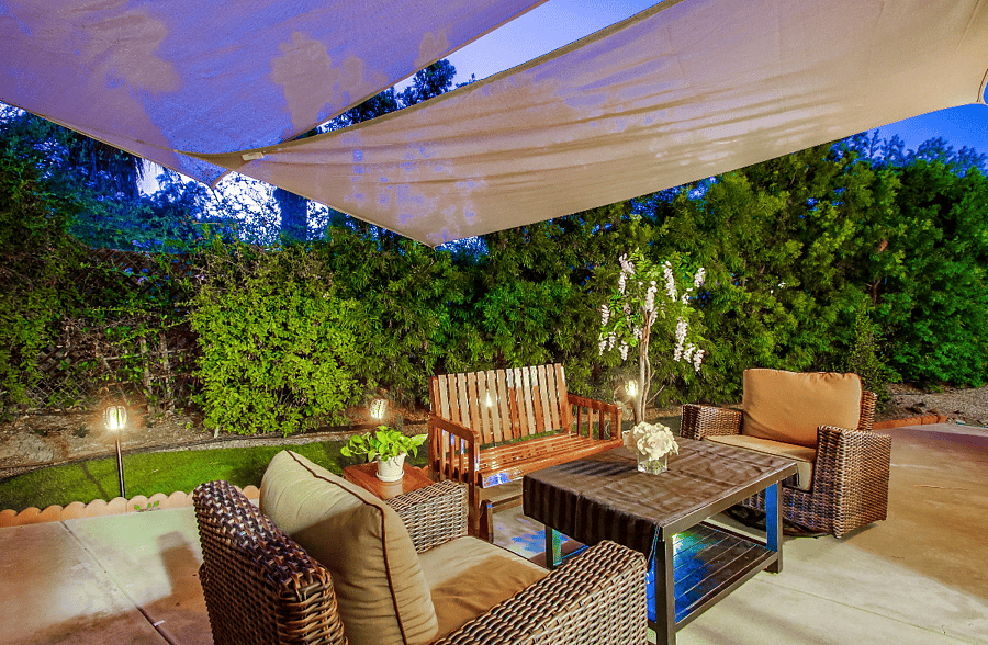 ChatGPT

The back patio, situated on the opposite side of the outdoor living space, adjoins the family room, providing both privacy and extra space for guests to gather in a distinct area.