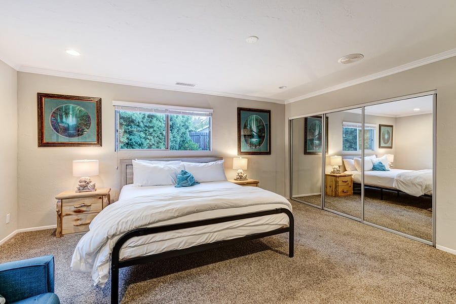 Bedroom Bedroom 2 features luxurious linens, a TV, and a spacious futon couch, offering ample comfort and relaxation for guests.