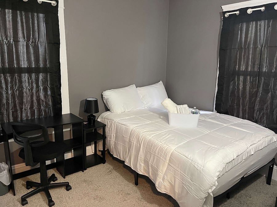 Bedroom 1: offers a cozy and inviting atmosphere, equipped with all the essentials for a comfortable stay. It features a full-size bed decked out in new linens, providing the perfect setting for a restful night's sleep. Storage needs are well met with a sleek dresser and convenient nightstand. Entertainment is just a click away with a Google Smart TV, ideal for relaxing movie nights or catching up on your favorite shows. The room also includes a well-appointed workspace with a desk, lamp, and office chair, catering to both relaxation and productivity needs. This bedroom is designed to offer a harmonious blend of comfort and utility, making it a delightful retreat.


