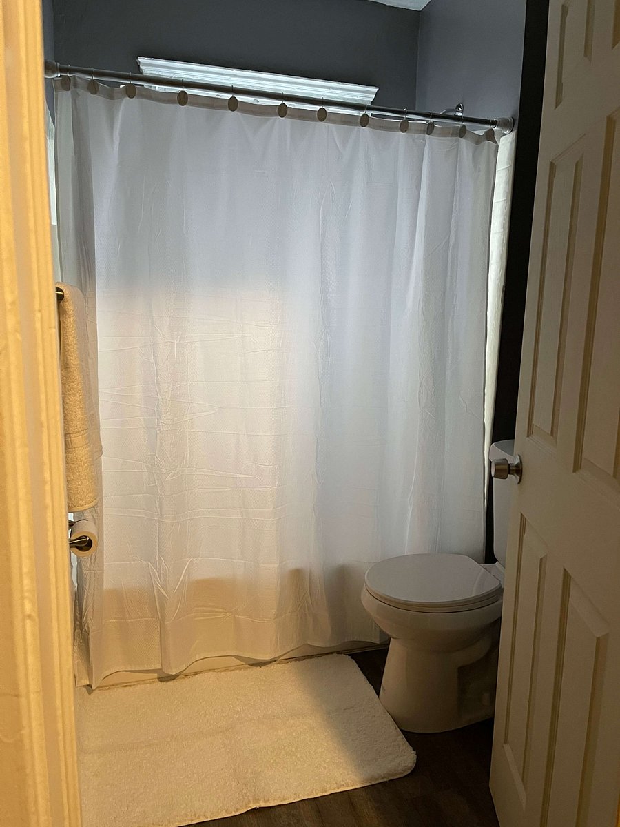 Experience the convenience and cleanliness of this well-appointed bathroom, featuring both a shower and tub for your relaxation and bathing preferences. The space is equipped with a stylish vanity and a large mirror, perfect for daily routines. Enjoy the added benefit of weekly cleaning services to ensure the bathroom remains spotless and hygienic throughout your stay.