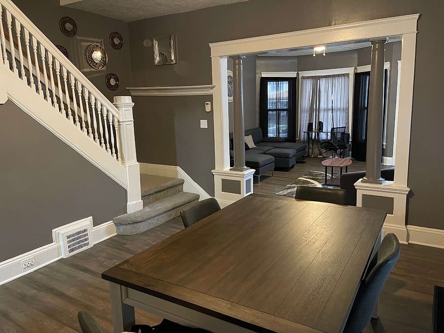Enjoy the comfort and functionality of this well-designed dining room. It's centered around a large dining table accompanied by four chairs, providing a perfect setting for family meals or entertaining guests. The room's expansive open space ensures a relaxed, uncluttered environment. A cozy window seat adds a touch of charm and a nice spot to relax after a meal, while built-in storage cabinets offer convenient access to tableware and other dining necessities.