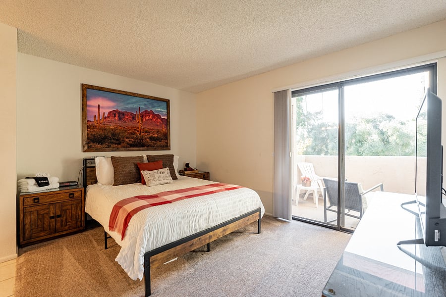 Cozy Master ensuite offering a queen bed and balcony entry.