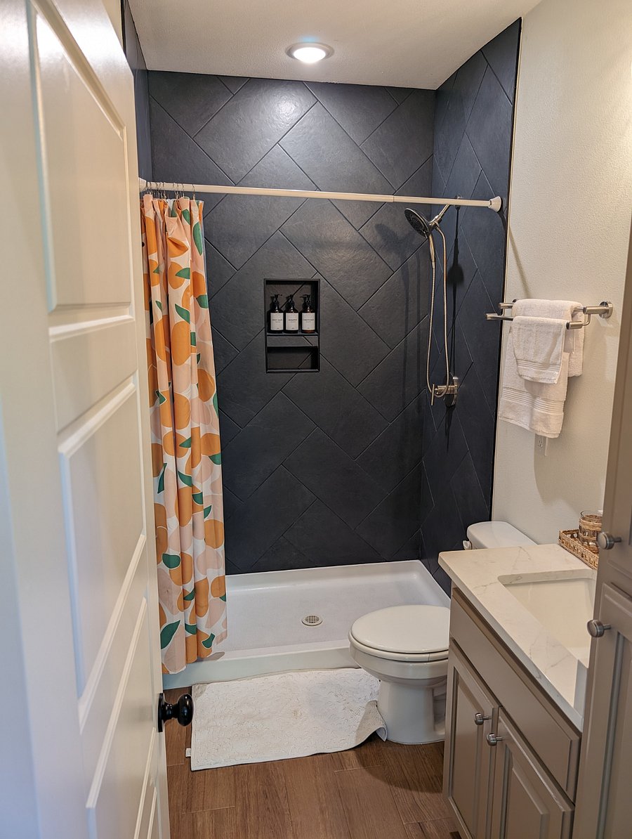 Bathroom with tile shower and ample storage