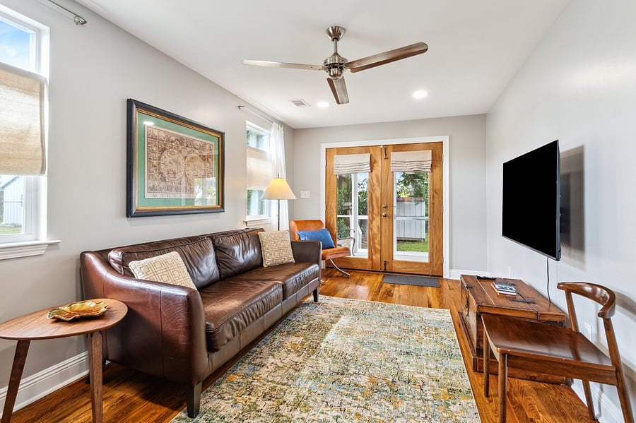 Through the living room, you'll have access to the amazing screened in back porch and the large backyard.