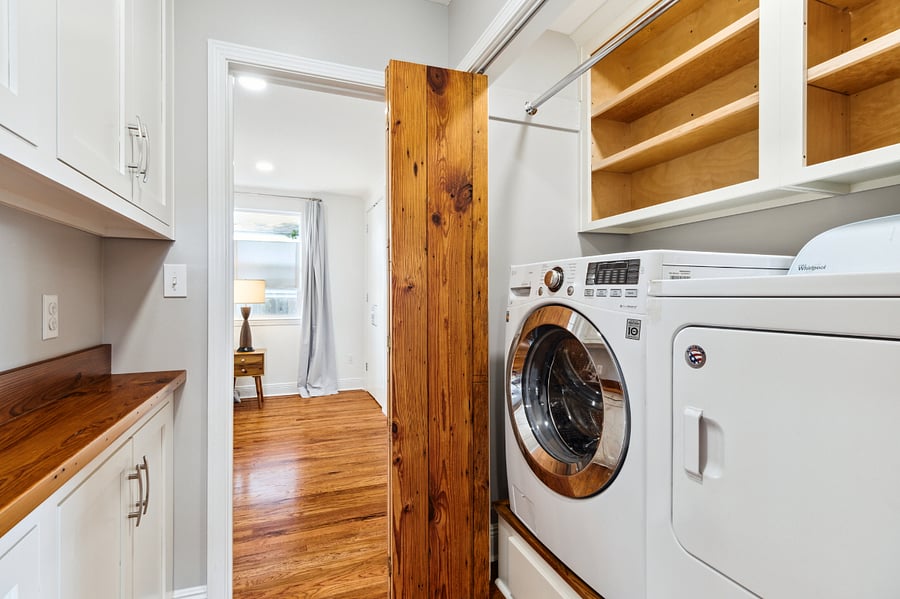 The in-unit washer/dryer is located between the living room and the primary suite.