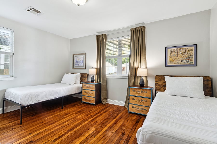 The Twin bedroom features 2 twin beds, a large un-pictured dresser and closet for added storage, and a smart TV.