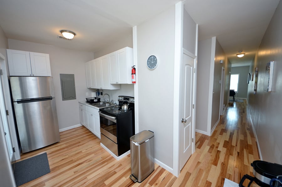 Kitchen With Full Sized Fridge, Electric Stove, Deep Sink, Microwave & Everything You Would Need Tp Prepare A Meal