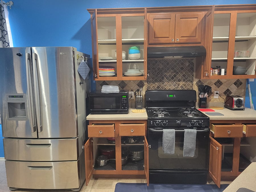 Full kitchen with fridge water dispenser and ice maker, gas stove, microwave
Plates bowls pots and pans