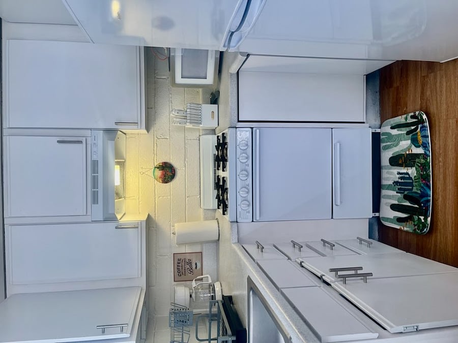 The fully equipped kitchen boasts a gas stove, drip coffee pot, microwave oven and refrigerator.
