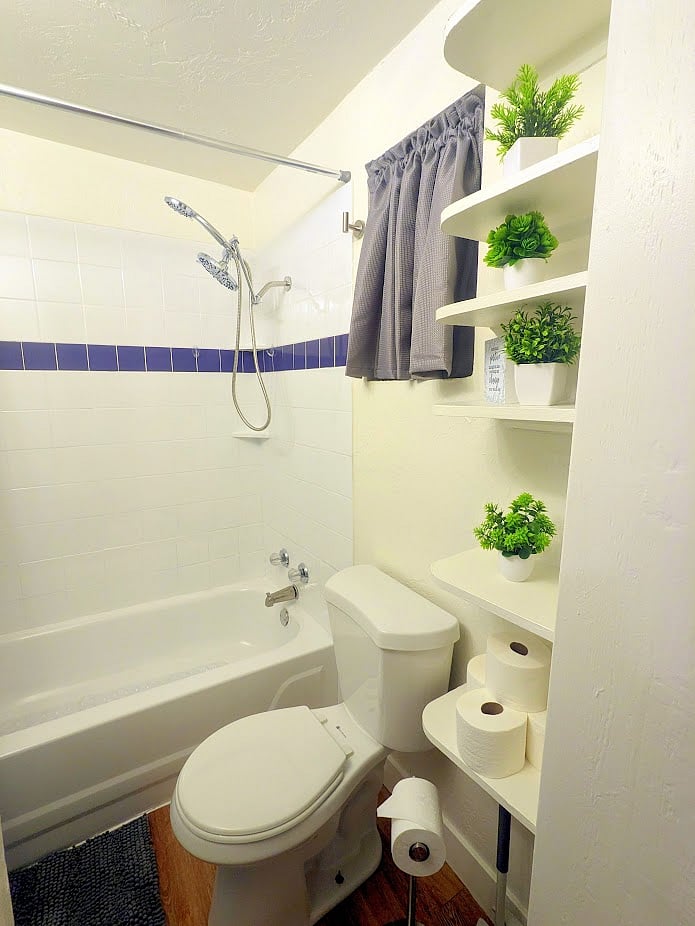 A full-size shower/bath tub equipped with a rainfall shower head.