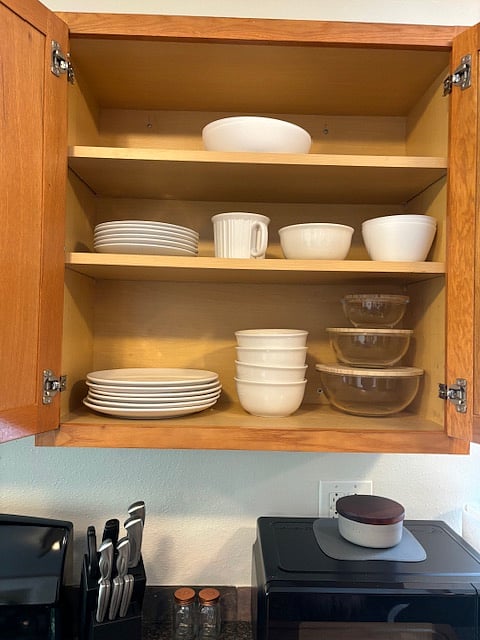 Fully stocked kitchen with dishes and utensils.
