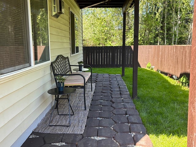 Fully fenced, private patio with seating area.