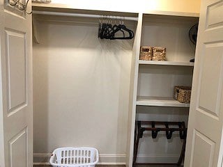 Closet with lots of storage for clothes and luggage with motion detector light.