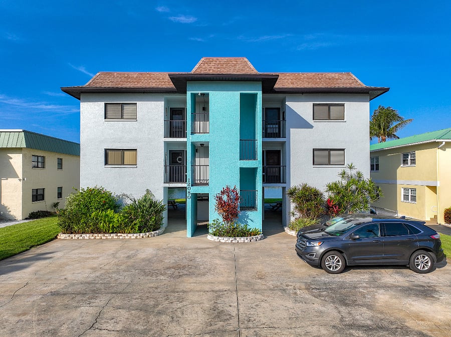 Front of building with 2 parking spots