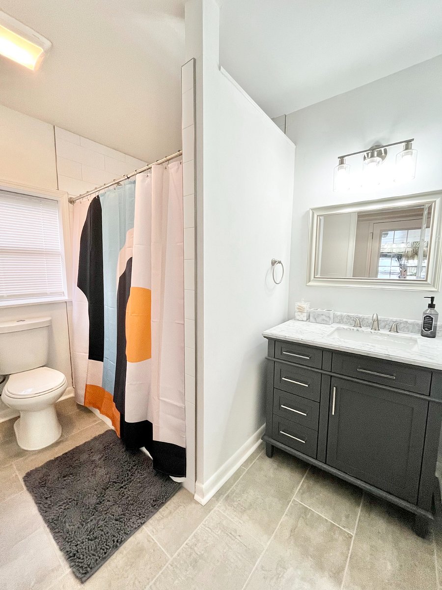 Downstairs bathroom has an oversized tile shower with double heads.
