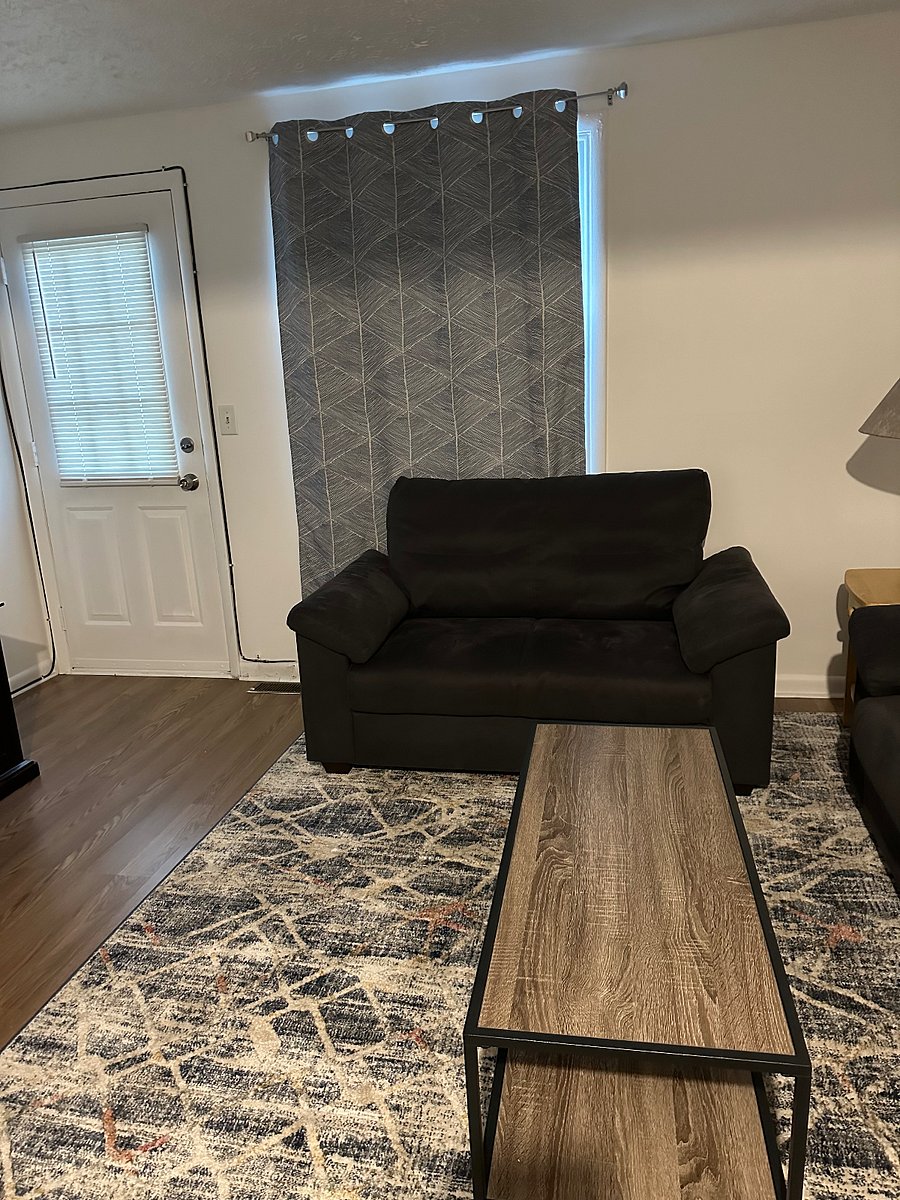 Grey loveseat in the living room, facing the TV.