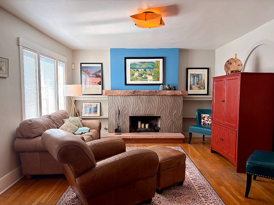 Large living room with leather couch and chair.