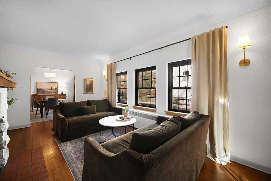 Living/sitting room with two couches, coffee table, bookshelf, fireplace, entry table, dimmable lights. Great place for reading and conversations and the best seat in the house for watching snow and rainstorms. Living room flows into the dining room. 
