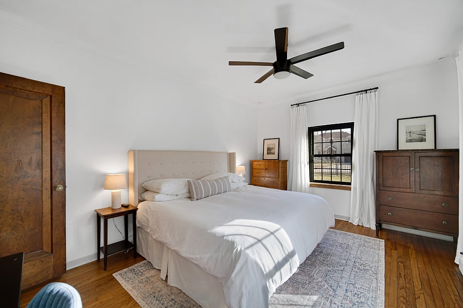 King bedroom with nightstands, 2 dressers, flatscreen TV, desk and closet. The morning light through these windows is magic. 