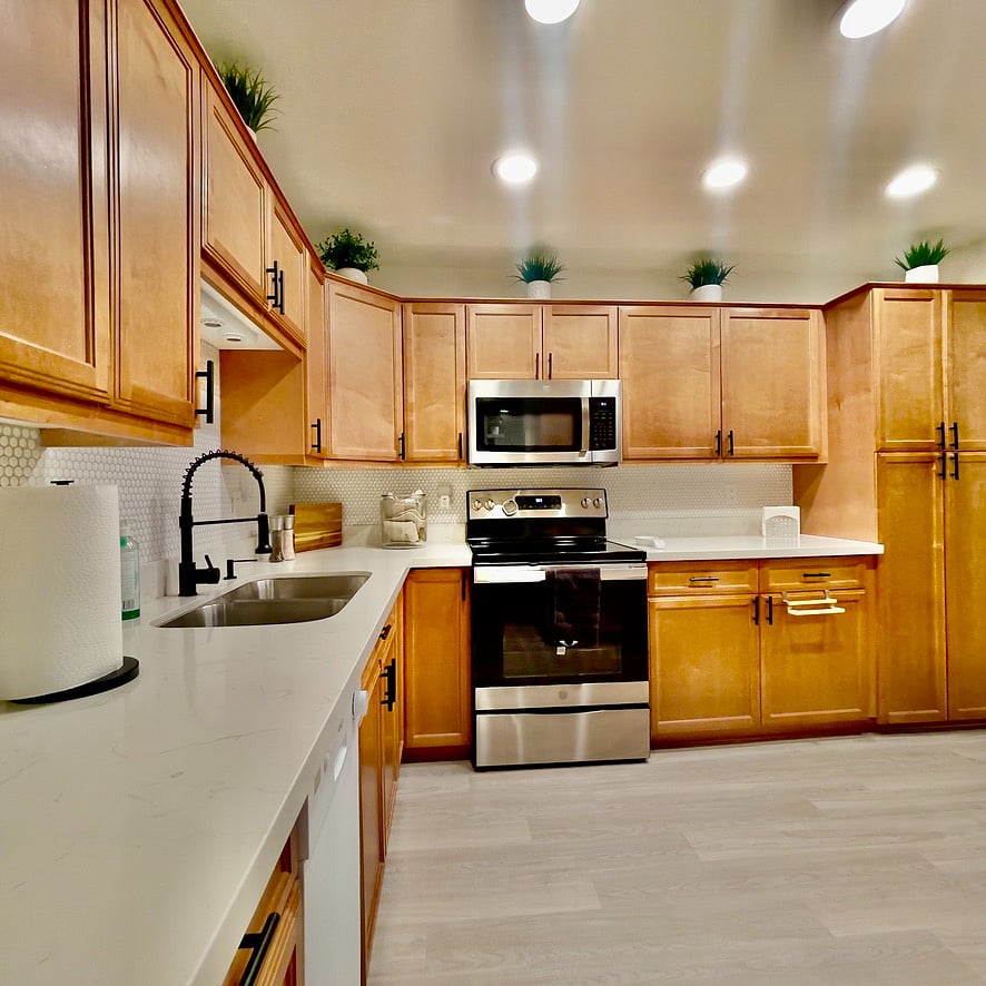 Full sized stainless steel refridgerator and stove.