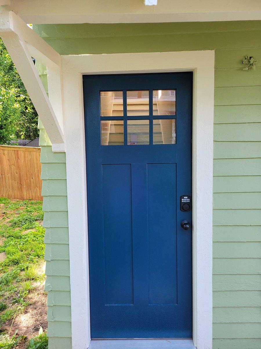Exterior entrance and steps up to apartment entrance with keyless keypad lock.