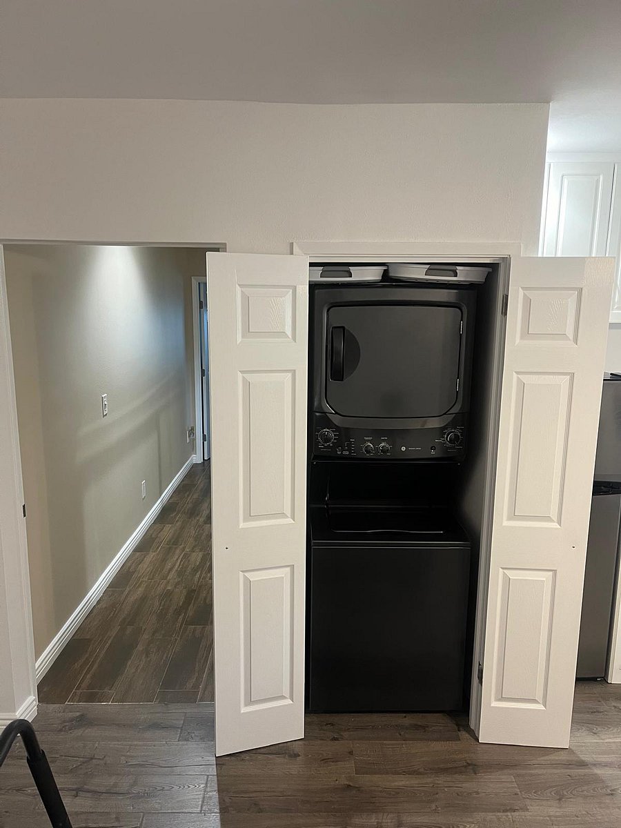 Hallway from living room/dining room/kitchen to bedrooms. Washer and dryer in unit next to kitchen. Two collapsible plastic laundry baskets available. 