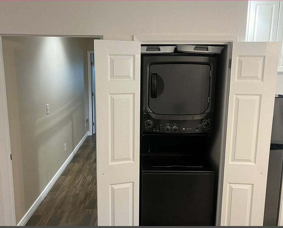Hallway to Bedrooms and washer and dryer in unit next to kitchen. Two collapsible plastic laundry baskets available. 